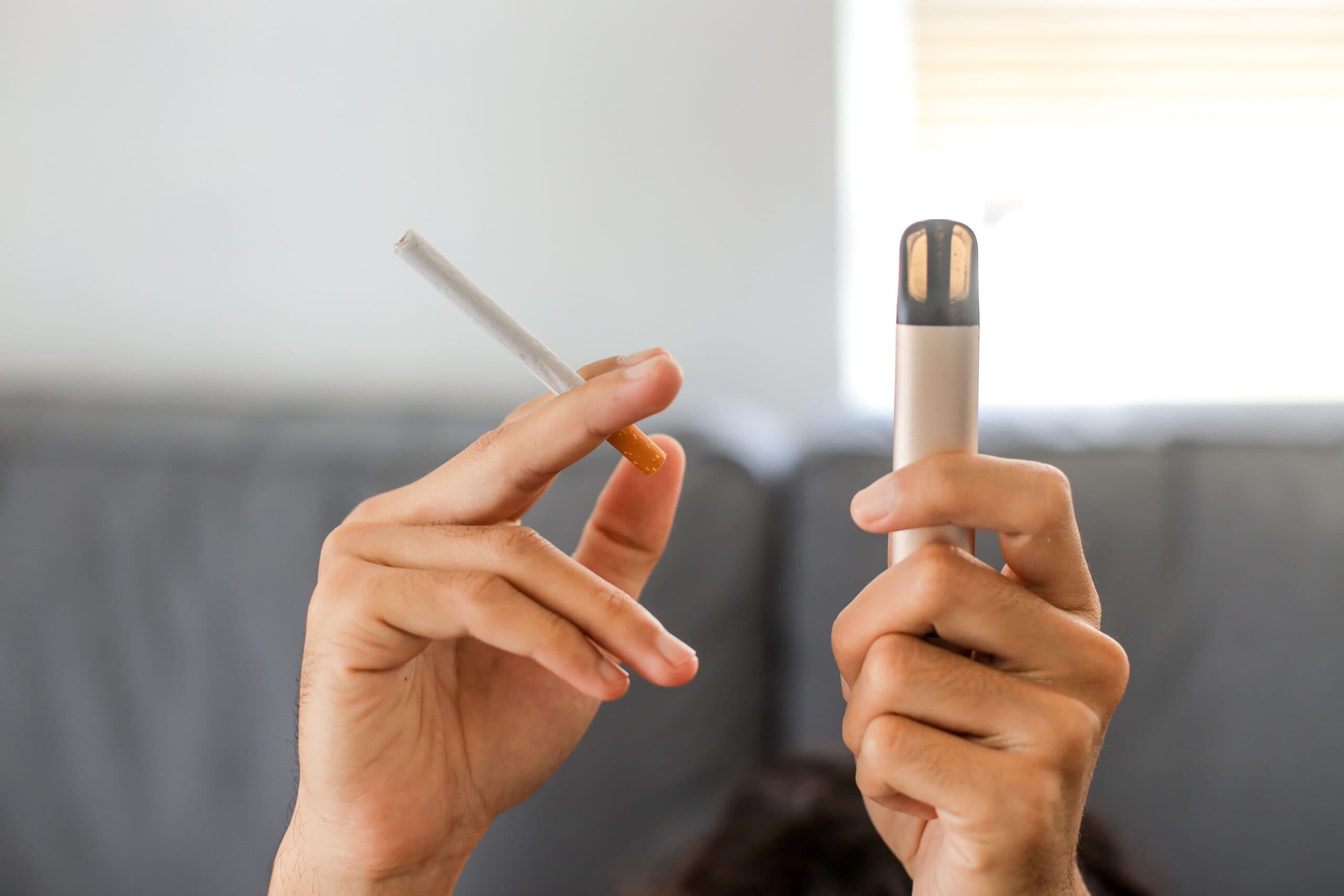 Smoker comparing tobacco and menthol vape juice options for switching to vaping