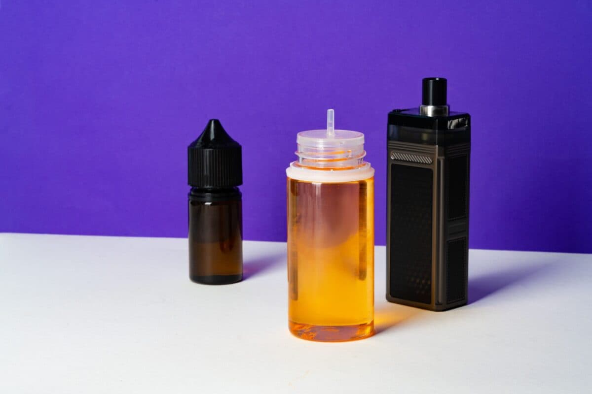 Nicotine salt e-liquids and a vape device placed against a purple background, perfect for smoother and more satisfying vaping experiences